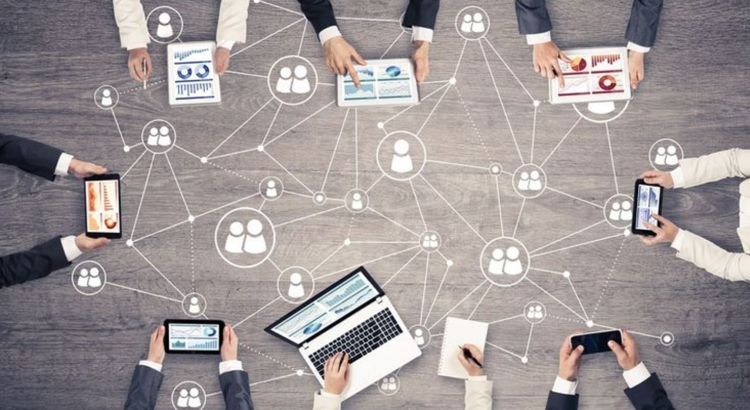 people are taking down notes while checking their laptops